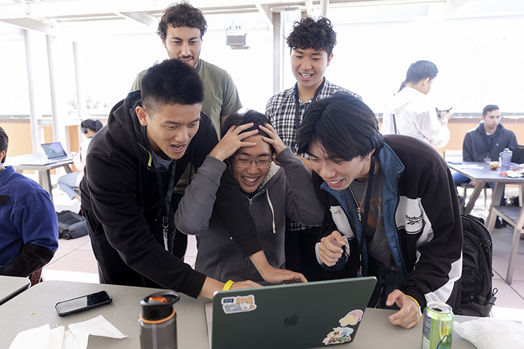 Hackers sitting in front of a computer screen perplexed.