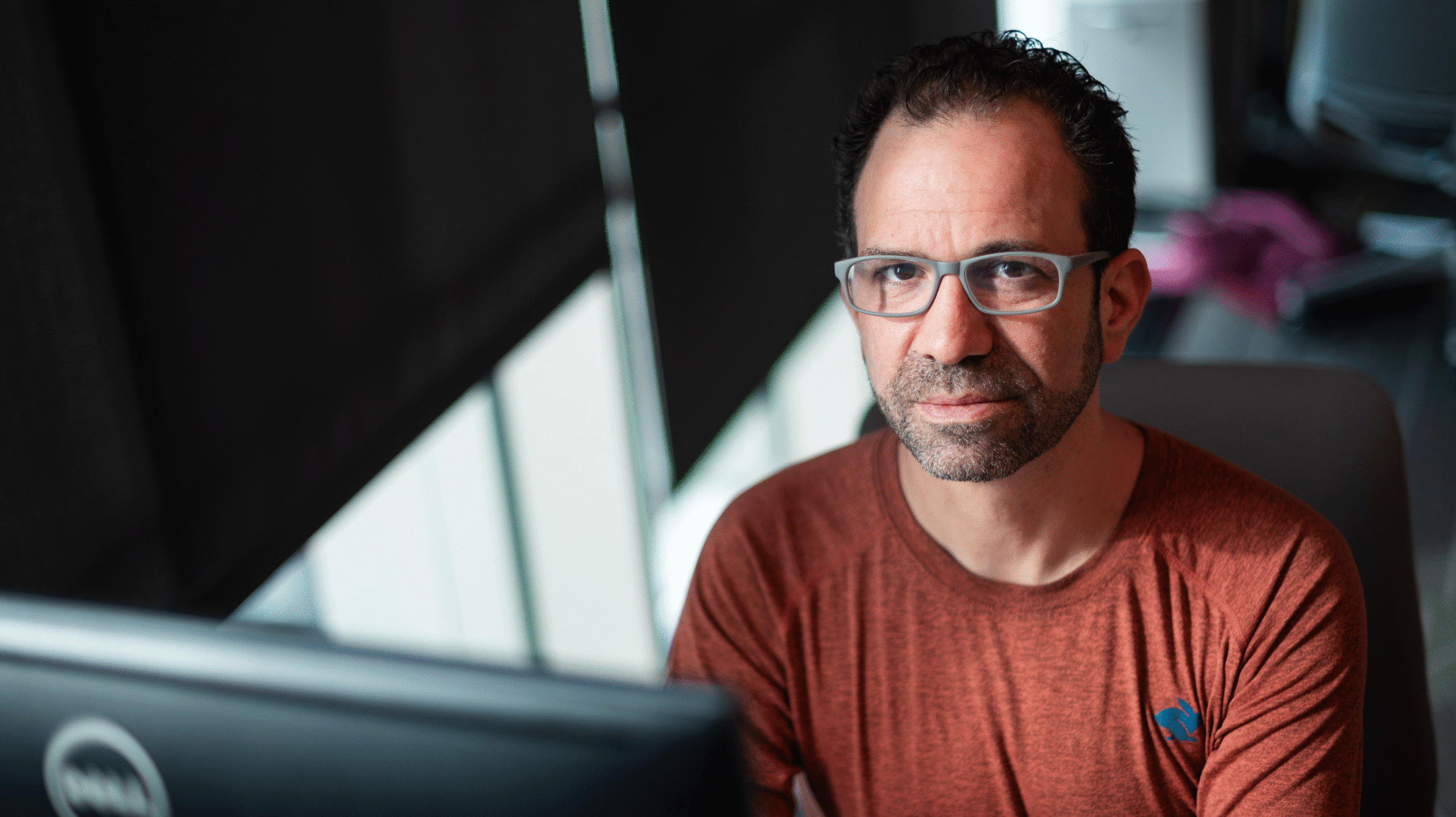 Jonathan Stray, a computer scientist at UC Berkeley, sits at a computer in edgy light