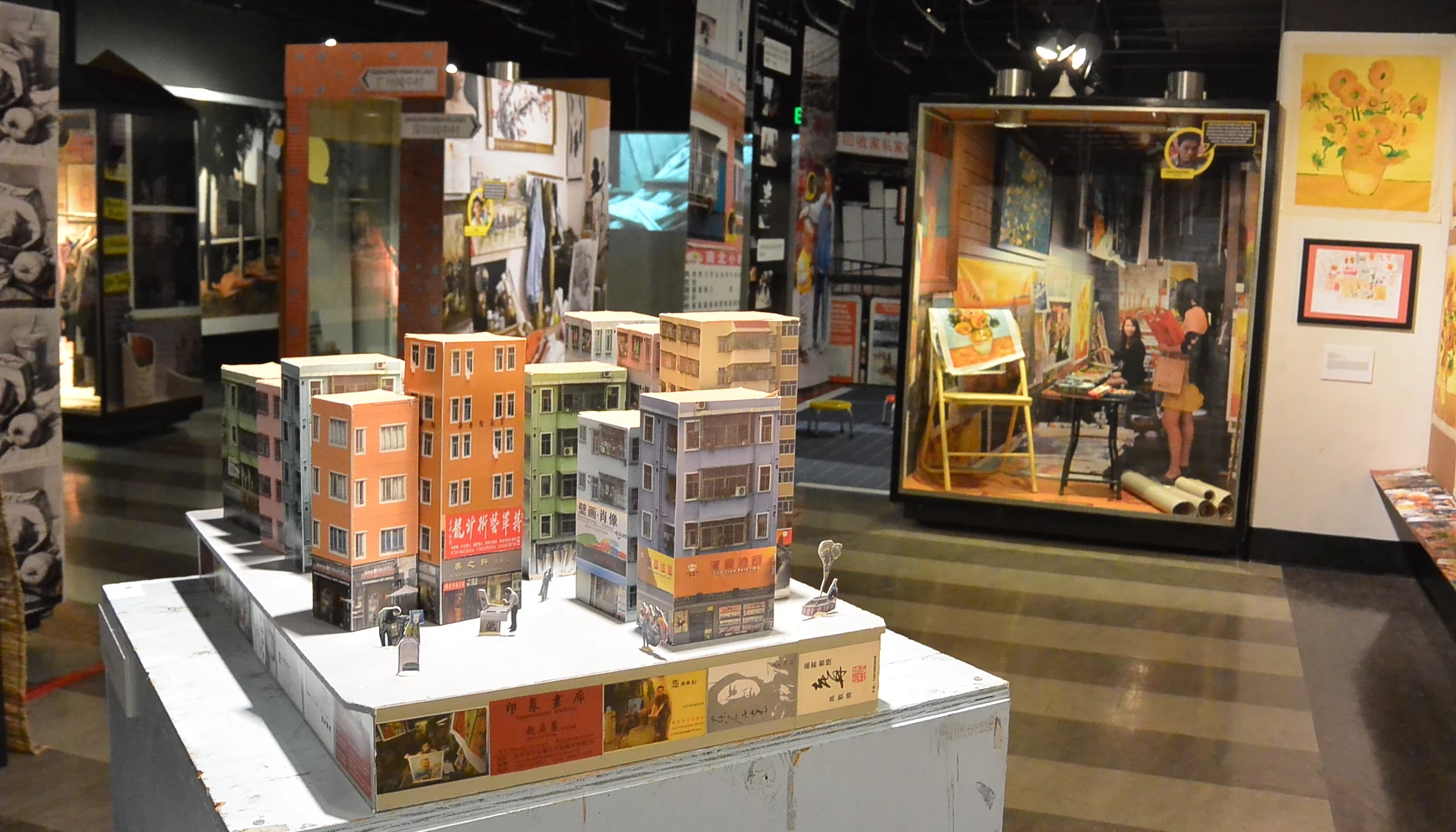 An art exhibition with a model of the dozen buildings of Dafen Oil Painting Village in the foreground