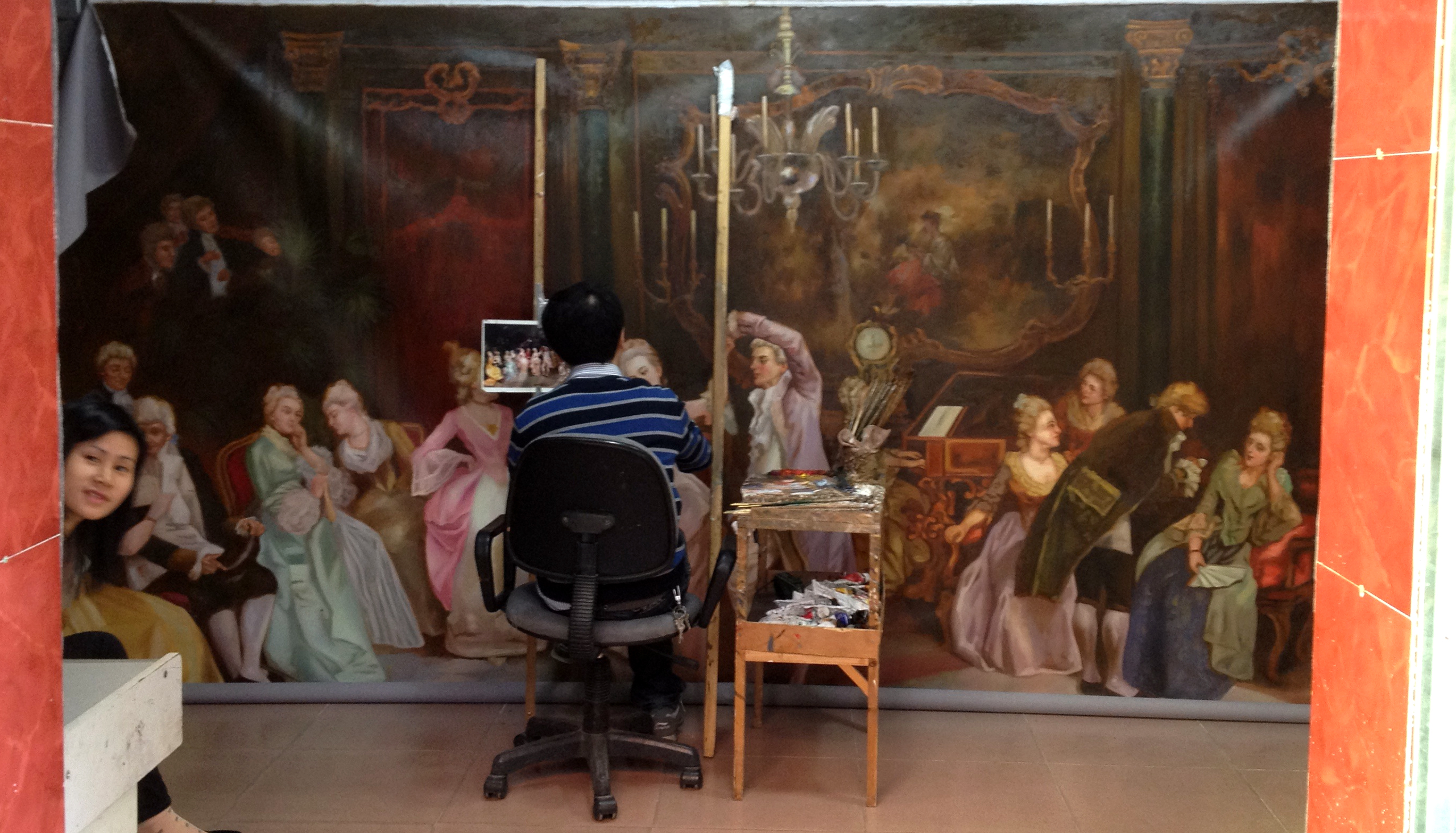 an artist paints a large painting