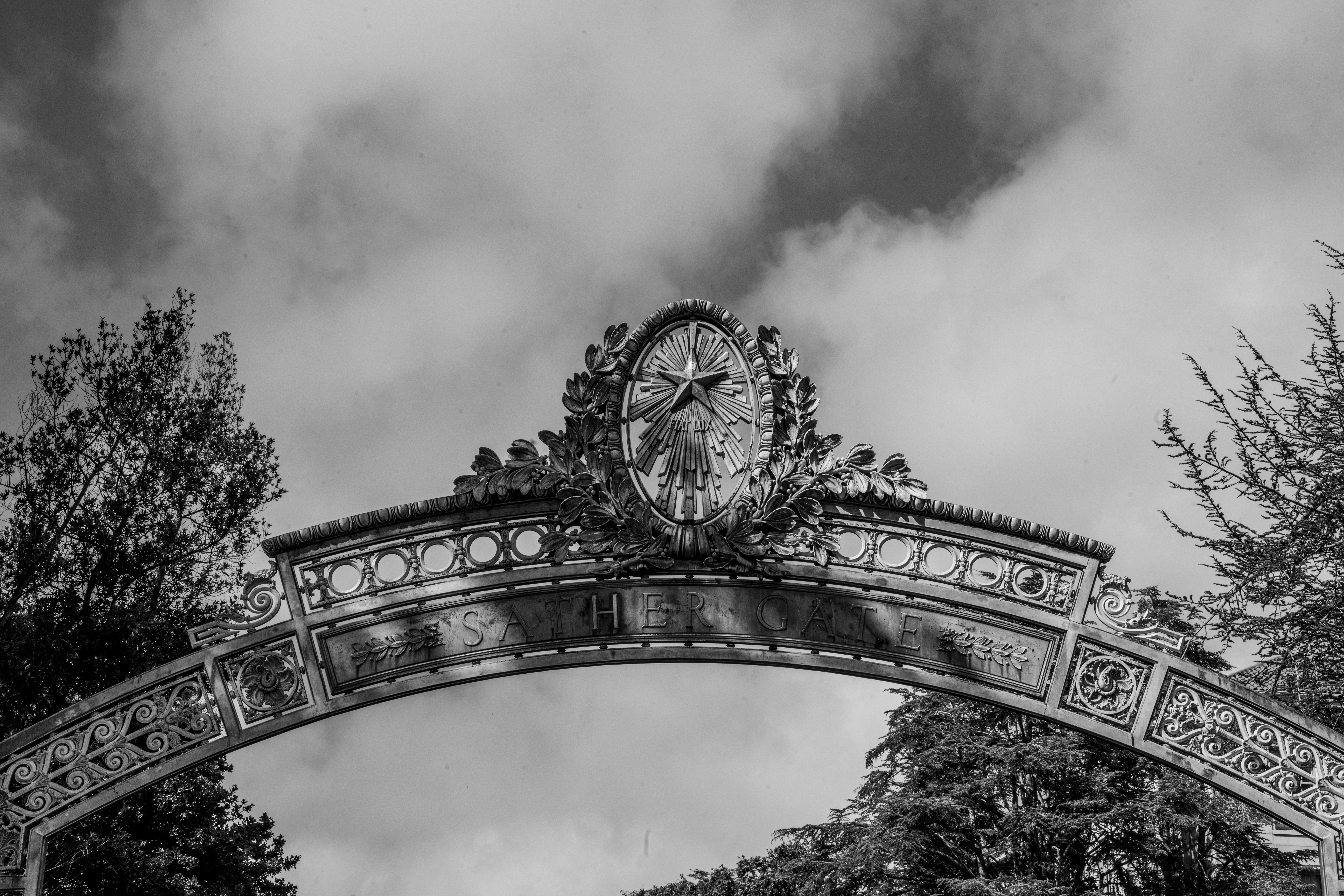 A photo of Sather Gate on the UC Berkeley campus in black and white