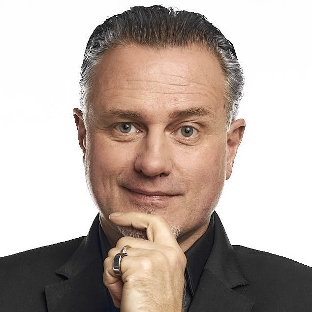 headshot of Olaf J. Groth with hand to chin, against white background
